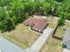 Expansive aerial view reveals lush landscaping, highlighting the property's serene setting and convenient concrete driveway at 4973 Sw 107Th Loop, Ocala, FL 34476