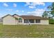 Expansive backyard featuring a covered, screened-in patio and lush green grass at 4973 Sw 107Th Loop, Ocala, FL 34476