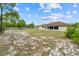 The backyard is fully fenced, with a well-maintained lawn and mature trees, providing privacy and a natural setting at 4973 Sw 107Th Loop, Ocala, FL 34476