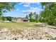 Expansive backyard featuring a lush lawn, mature trees, and a screened-in porch, ideal for outdoor living at 4973 Sw 107Th Loop, Ocala, FL 34476