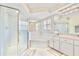Elegant bathroom offering a shower, tub, and dual sinks, perfect for a relaxing experience at 4973 Sw 107Th Loop, Ocala, FL 34476
