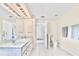 Bright primary bathroom with double sinks, cabinets, and a doorway to the bedroom at 4973 Sw 107Th Loop, Ocala, FL 34476