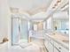 Luxurious bathroom featuring a glass-enclosed shower, tub, and dual sinks for a spa-like experience at 4973 Sw 107Th Loop, Ocala, FL 34476