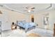 Inviting bedroom featuring a ceiling fan, trey ceiling and nearby access to the ensuite bathroom and walk-in closet at 4973 Sw 107Th Loop, Ocala, FL 34476