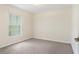 This carpeted bedroom is brightly lit by a window with views of the outside at 4973 Sw 107Th Loop, Ocala, FL 34476