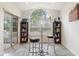 Bright dining area featuring a large window, two stools, and elegant built-in bookshelves at 4973 Sw 107Th Loop, Ocala, FL 34476
