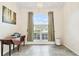 Sunlit dining room with a large window and elegant decor; a charming, inviting space at 4973 Sw 107Th Loop, Ocala, FL 34476