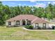 Inviting single-story residence with well-maintained lawn and mature trees, providing a serene setting at 4973 Sw 107Th Loop, Ocala, FL 34476