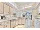 Bright kitchen with white cabinetry, modern appliances, and a breakfast bar overlooking the dining area at 4973 Sw 107Th Loop, Ocala, FL 34476