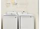 A laundry room featuring a washer, a dryer and shelf storage above at 4973 Sw 107Th Loop, Ocala, FL 34476