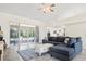 Open-concept living area with tile flooring, a large sectional sofa, and sliding glass doors to the outdoors at 4973 Sw 107Th Loop, Ocala, FL 34476