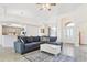 Inviting living space with a comfortable blue sectional sofa, a white coffee table, and seamless access to the kitchen at 4973 Sw 107Th Loop, Ocala, FL 34476