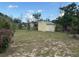 View of backyard with shed and some trees; partly shaded, surrounded by chain link fence at 499 Water Rd, Ocala, FL 34472