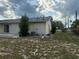 A spacious backyard with a patio and sliding glass doors leading into the house at 499 Water Rd, Ocala, FL 34472