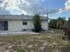 Backyard with a patio and sliding glass doors leading to the house at 499 Water Rd, Ocala, FL 34472