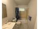 Full bathroom with sink, toilet, and shower/tub combo featuring shower curtain at 499 Water Rd, Ocala, FL 34472