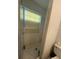 Bathroom with tile shower, tile floors, toilet, and window at 499 Water Rd, Ocala, FL 34472
