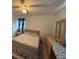 Bedroom with ceiling fan, dresser, bed, and a night stand at 499 Water Rd, Ocala, FL 34472