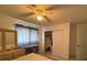 Bedroom with ceiling fan, dresser, walk-in closet, and an ironing board at 499 Water Rd, Ocala, FL 34472