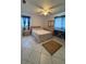 This bedroom includes a ceiling fan, tile floors, bed, nightstand, and dresser at 499 Water Rd, Ocala, FL 34472