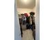 Walk-in closet with clothes and luggage on shelving and hanging racks at 499 Water Rd, Ocala, FL 34472