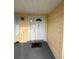 Entrance to the property featuring yellow siding, a white door, and front steps at 499 Water Rd, Ocala, FL 34472