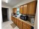 Kitchen featuring wooden cabinets, stainless steel sink, and tile backsplash at 499 Water Rd, Ocala, FL 34472
