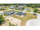 Back exterior showcasing a new home with a gray roof, and a concrete patio in a partially landscaped backyard at 5 Dogwood Loop Ave, Ocala, FL 34472