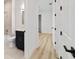 Hallway view of a bathroom with stylish vanity and bath-shower combination at 5 Dogwood Loop Ave, Ocala, FL 34472
