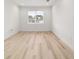 Bright bedroom features hardwood floors, recessed lighting, and a view to the neighborhood at 5 Dogwood Loop Ave, Ocala, FL 34472