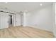 Spacious bedroom featuring hardwood floors and a sliding barn door to the bathroom at 5 Dogwood Loop Ave, Ocala, FL 34472