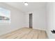 Bright bedroom with light wood floors, white walls, and a closet at 5 Dogwood Loop Ave, Ocala, FL 34472