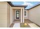 Close-up of front entrance highlighting door and modern architectural details at 5 Dogwood Loop Ave, Ocala, FL 34472