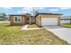 Exterior view of the modern home with attached garage and freshly landscaped front yard at 5 Dogwood Loop Ave, Ocala, FL 34472