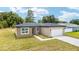 Charming single-story home with a well-maintained lawn and attached two car garage at 5 Dogwood Loop Ave, Ocala, FL 34472