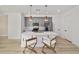 Modern kitchen with pendant lighting, gray cabinets, and a spacious island with bar seating at 5 Dogwood Loop Ave, Ocala, FL 34472