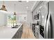 Bright, modern kitchen with quartz countertops, stainless steel appliances and views to other living areas at 5 Dogwood Loop Ave, Ocala, FL 34472