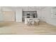 Modern kitchen and living space with light wood flooring and gray cabinets at 5 Dogwood Loop Ave, Ocala, FL 34472