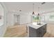 Bright, new kitchen with a quartz countertop island, stainless faucet, and an open floorplan at 5 Dogwood Loop Ave, Ocala, FL 34472