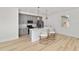 Modern kitchen featuring gray cabinets, stainless steel appliances, and a quartz countertop island with seating at 5 Dogwood Loop Ave, Ocala, FL 34472