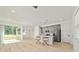 Modern kitchen and living space featuring light wood flooring and gray cabinets at 5 Dogwood Loop Ave, Ocala, FL 34472