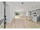 Open-concept living area with a modern kitchen and light wood flooring at 5 Dogwood Loop Ave, Ocala, FL 34472