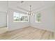 Bright living room featuring wood floors, large windows, and recessed lighting at 5 Dogwood Loop Ave, Ocala, FL 34472