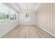 Bright living room featuring recessed lighting, modern light fixture, and large window at 5 Dogwood Loop Ave, Ocala, FL 34472