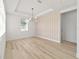 Bright living room with hardwood floors, modern lighting, and a decorative wall at 5 Dogwood Loop Ave, Ocala, FL 34472