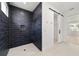 Modern bathroom boasts a stylish, tiled walk-in shower and barn-door access at 5 Dogwood Loop Ave, Ocala, FL 34472