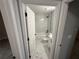Elegant bathroom featuring marble tile, a bathtub, and a modern vanity at 5 Laurel Pass Ln, Ocala, FL 34472