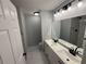 This bathroom features double sinks, modern lighting, and a marble-tiled shower at 5 Laurel Pass Ln, Ocala, FL 34472