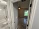 A partial view shows a bathroom with marble tile alongside a bedroom featuring wood-look tile flooring at 5 Laurel Pass Ln, Ocala, FL 34472