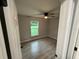 Cozy bedroom with a ceiling fan and a window offering natural light at 5 Laurel Pass Ln, Ocala, FL 34472
